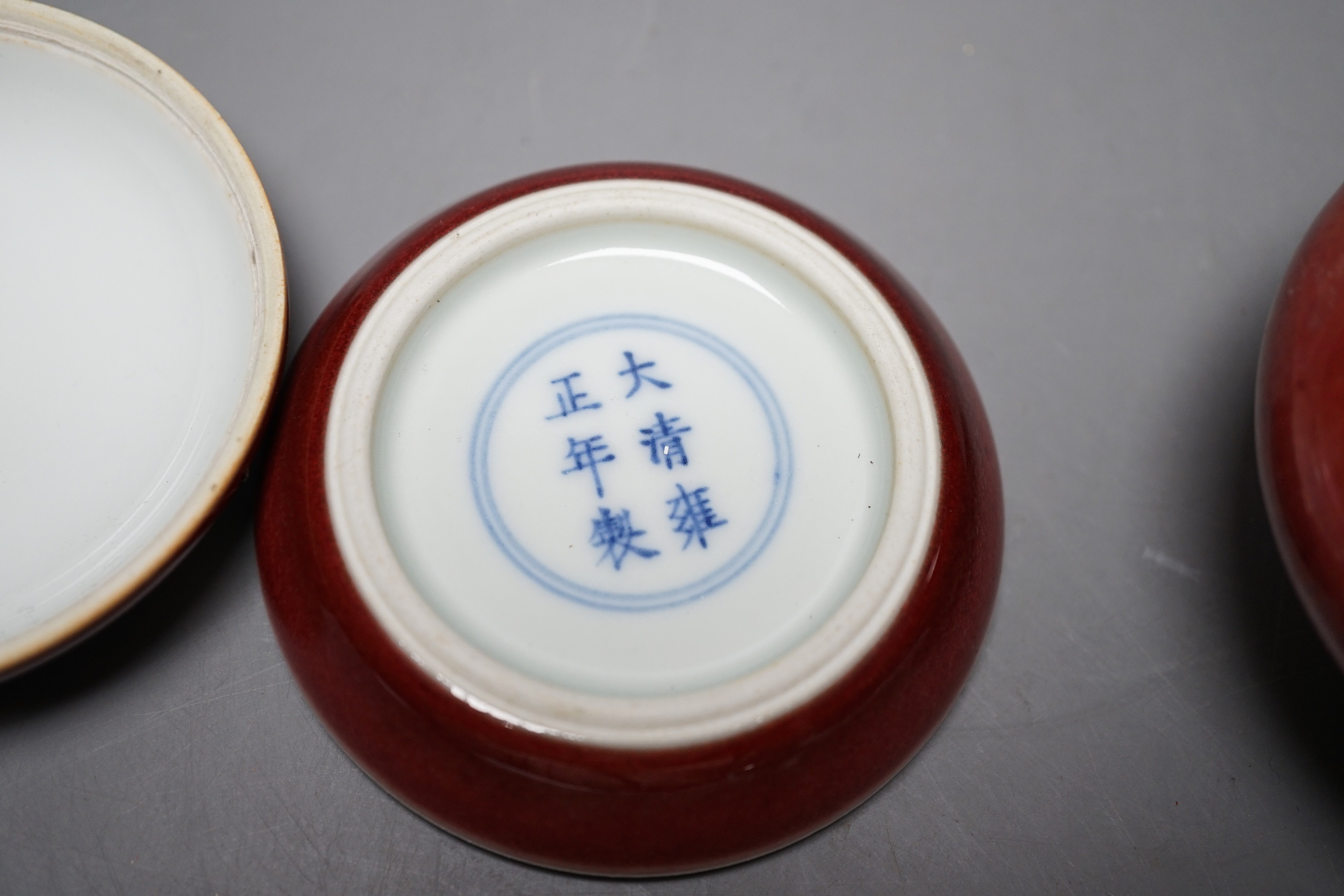 A Chinese sang de boeuf glazed seal paste box and a small pot (2) box 7.5cm diameter